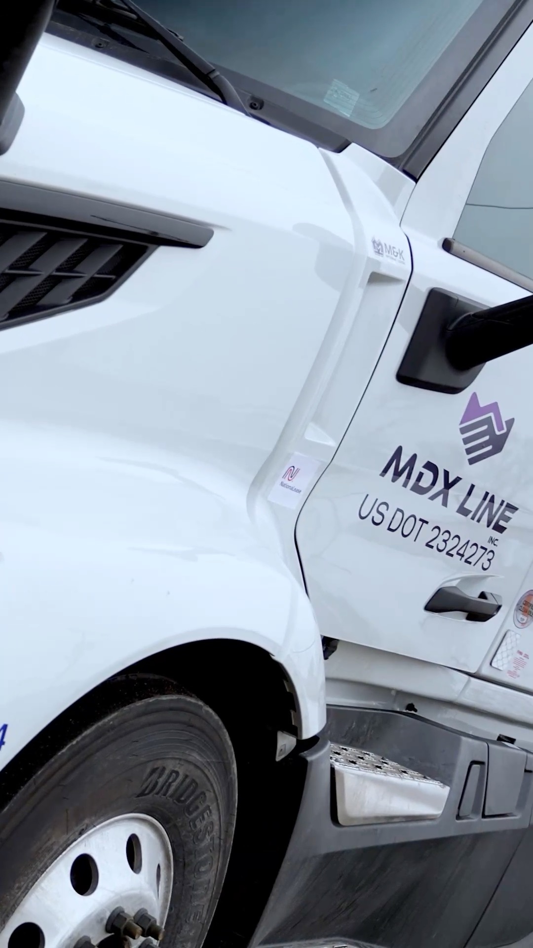 MDX Line truck branding close-up with logo and DOT number