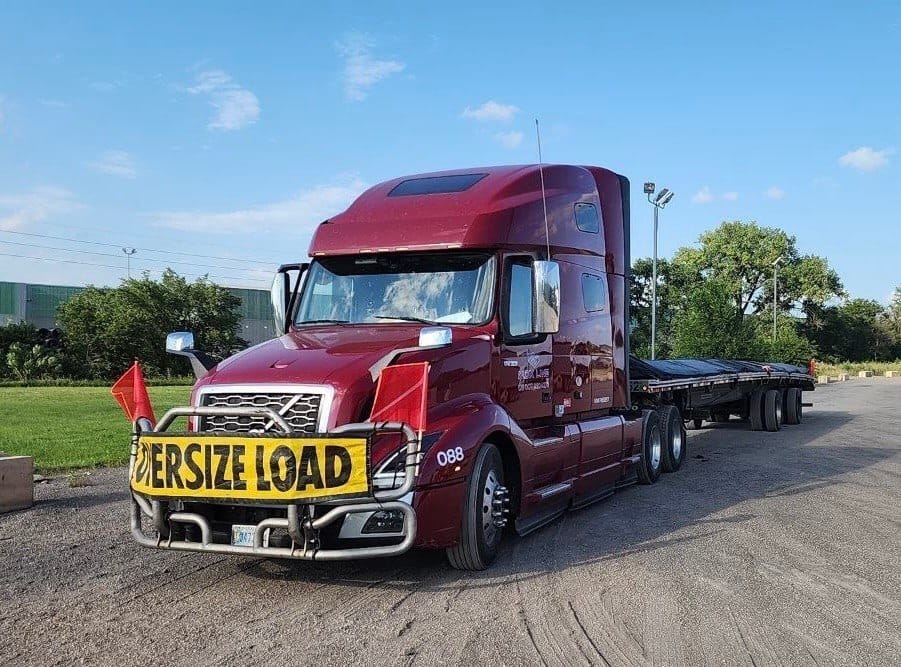MDX Line flatbed hauling an oversized load