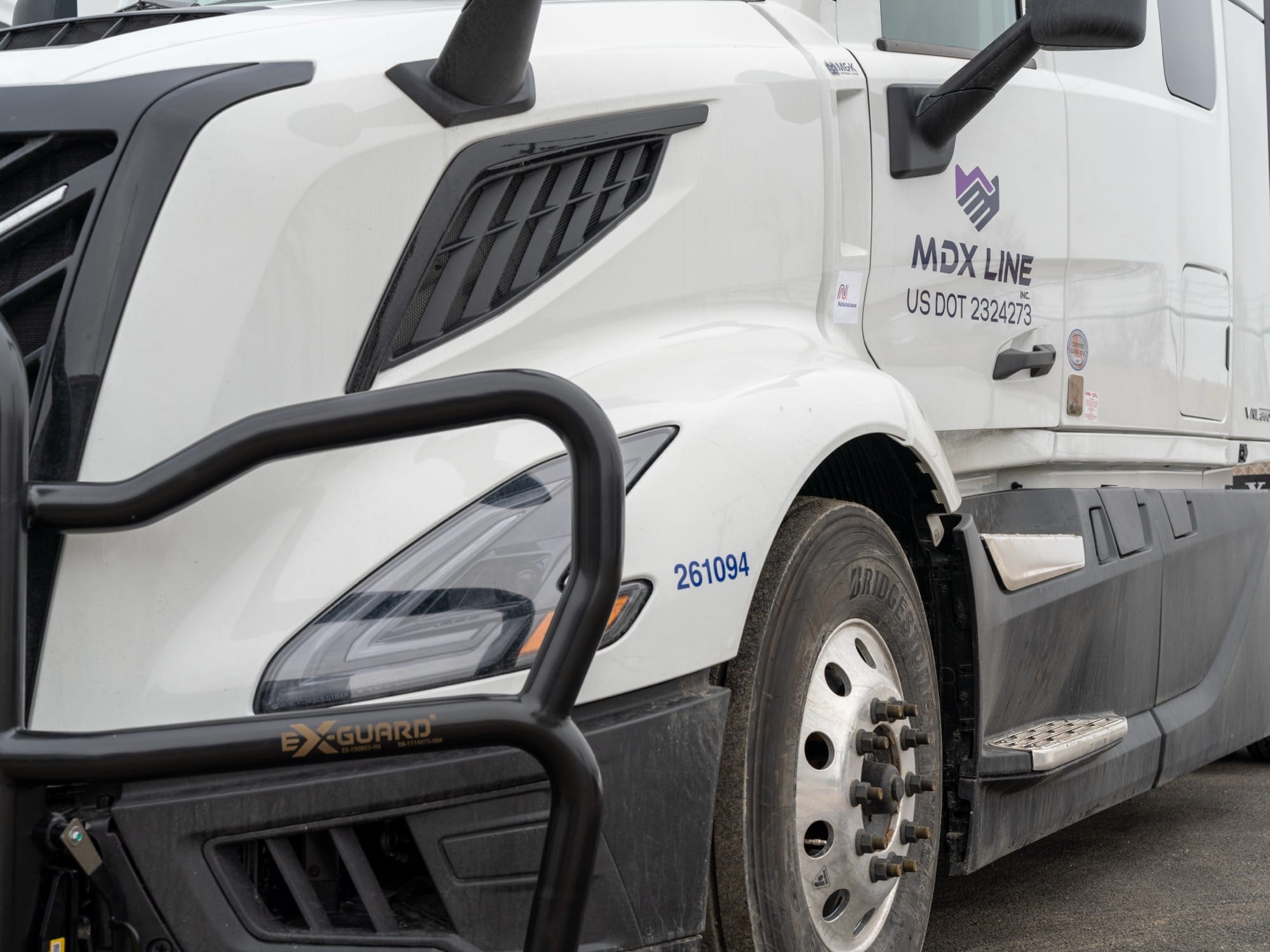 MDX Line truck close-up showing branding and DOT number